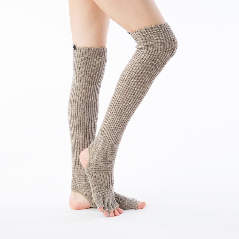 Side view of a woman's leg wearing the BEIGE color of the Knitido plus brand Wool Blend Confetti Ribbed Open Toe/Heel Yoga Leg Warmers Socks