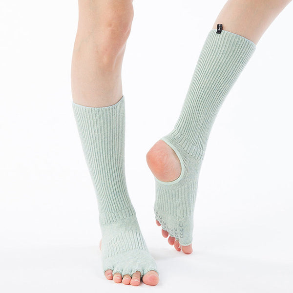 A front view of a woman's leg wearing Aqua color of Knitido plus brand's Botanical Dyed Organic Cotton Open Toe/Heel Yoga Socks