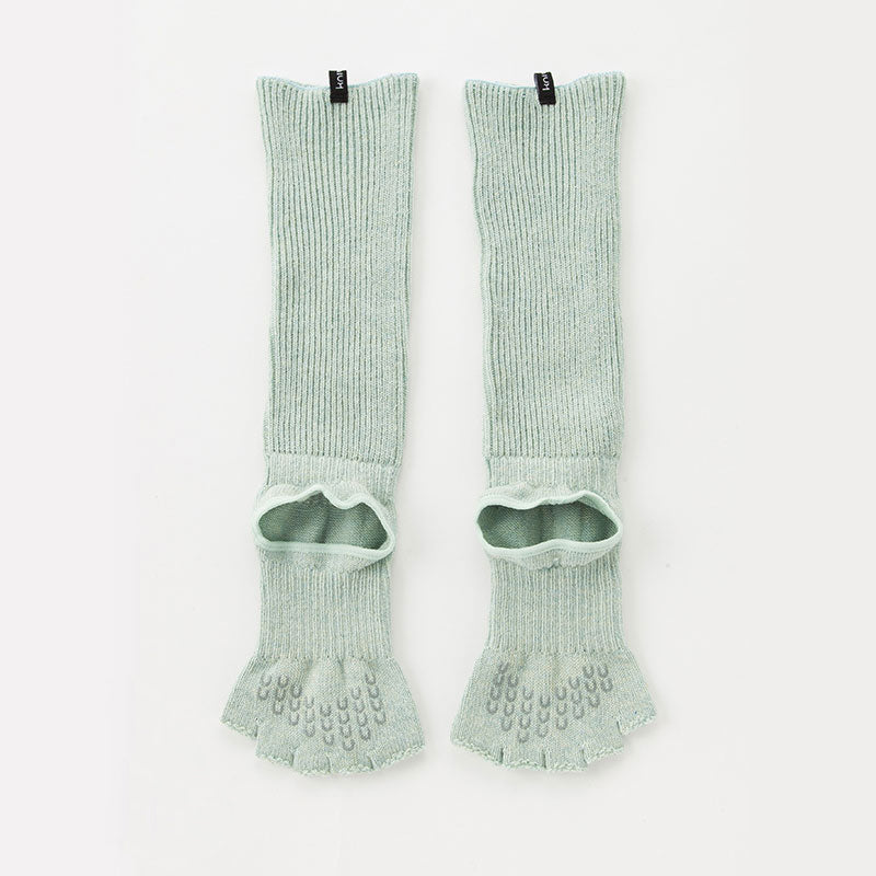 The backside of the Knitido plus brand Botanical Dyed Organic Cotton Open Toe/Heel Yoga Socks in the color Aqua, laid flat