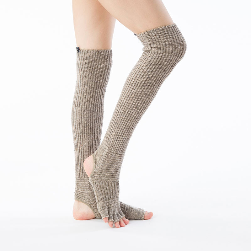 Side view of a woman's leg wearing the BEIGE color of the Knitido plus brand Wool Blend Confetti Ribbed Open Toe/Heel Yoga Leg Warmers Socks