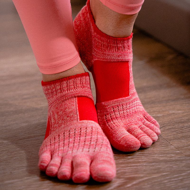 Woman's foot wearing Knitido plus brand Arch Support Heather Footie Grip Toe Socks With Power Pads product in red