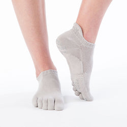Front view of below-knee foot wearing Knitido plus brand Basic Solid Colors Footie Grip Toe Socks With Power Pads in grey color