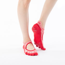 Woman's foot front view wearing Knitido plus brand Heather Toe Footie Grip Socks With Power Pads in red