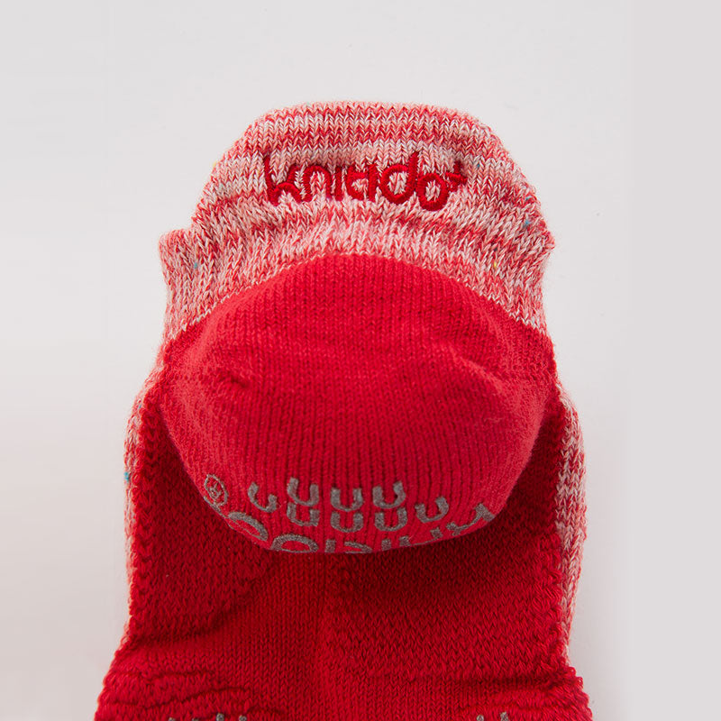 Enlarged red heel portion of Knitido plus brand Heather Toe Footie Grip Socks With Power Pads
