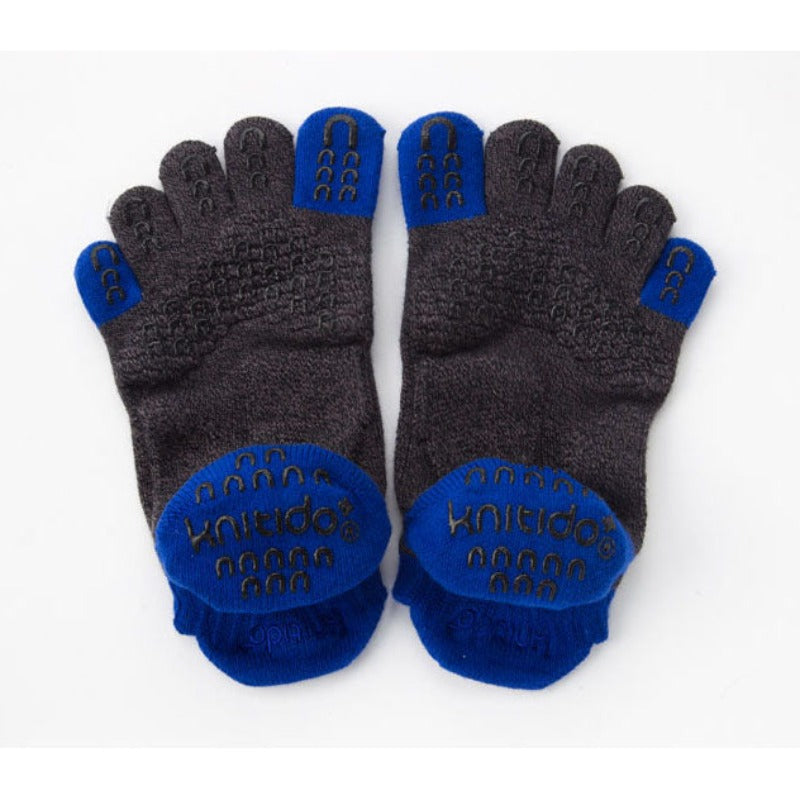 Backside photo of Two Colors Footie Grip Toe Socks With Power Pads by Knitido plus brand in blue with black inserts in the thumb and pinky toe area and at the footwear opening