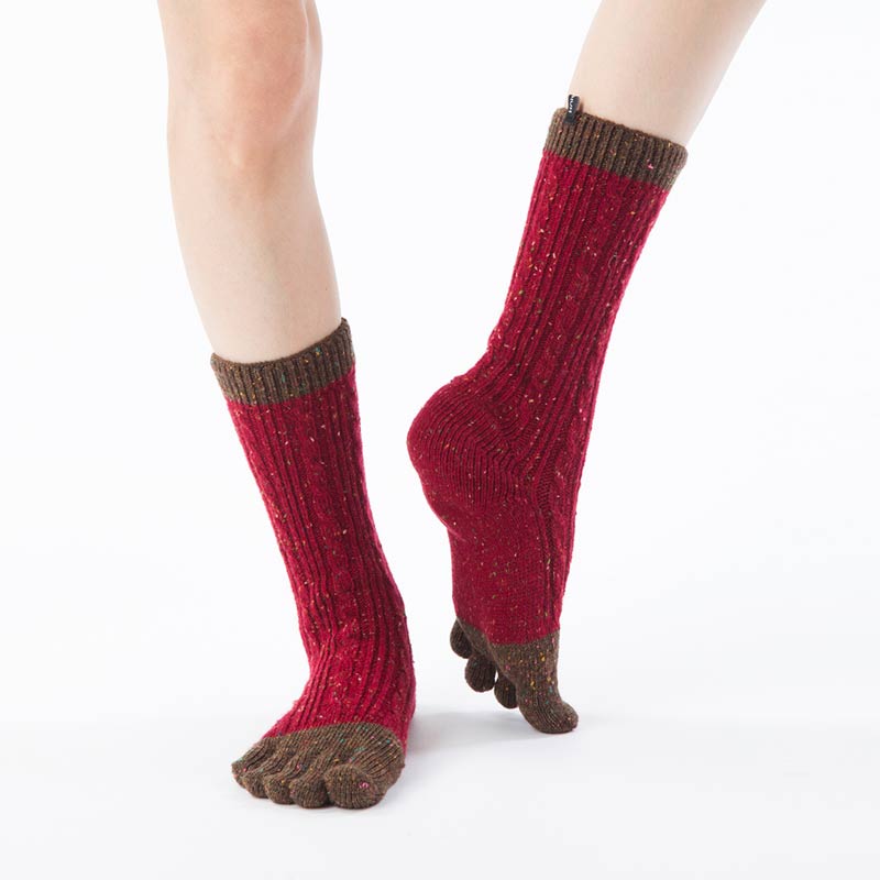Front view of a woman's leg wearing a pair of Knitido plus brand Wool Blend Cable Confetti Midcalf Toe Socks in a red color with khaki inserts at the toe and cuff of the foot