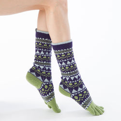 Side view of a woman's foot wearing a pair of Knitido plus brand Wool Blend Forest Textile Midcalf Toe Socks in purple with gray and yellow-green point colors